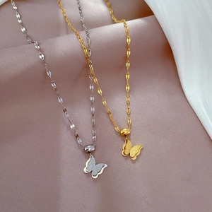 Close-up of double-layered butterfly pendant necklaces in gold and silver finish
