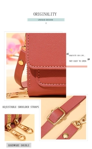 Detail of red-brown crossbody bag featuring heart zippers and gold hardware