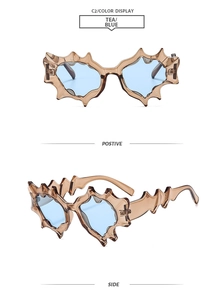Close-up of futuristic punk sunglasses with jagged frame and tea blue color display