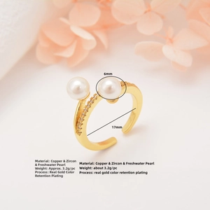 Detailed macro view of gold-plated open ring with two 6mm pearls and cubic zirconia