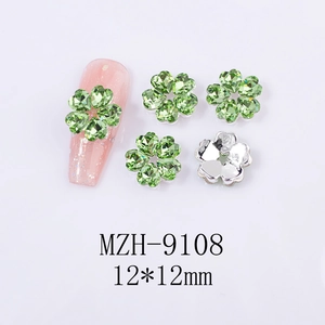 Macro view of green crystal clover nail art charms with silver backing and 12mm sizing