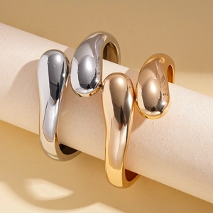 Minimalist polished silver and gold lava style open bracelets with fluid geometric design