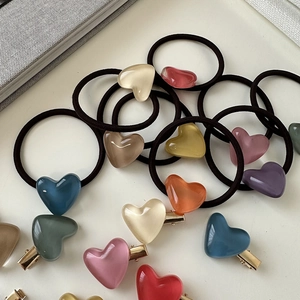 Detail of jelly heart hair clips and elastic bands in assorted macaron colors