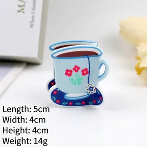 Detailed view of the 5x4cm blue coffee cup hair claw clip with floral patterns
