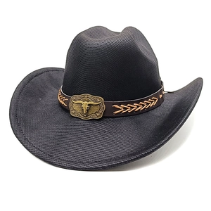 Detail of black woven cowboy hat with leather band and bronze bull skull ornament