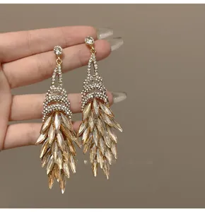 Detail of gold fringe earrings with champagne marquise crystals and pavé diamonds