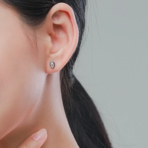Elegant marquise-cut cubic zirconia silver stud earrings on a female model's ear