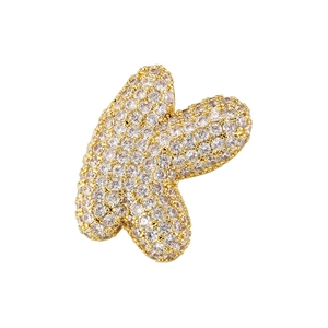 Detailed macro view of gold-plated puffy letter K pendant with cubic zirconia inlay