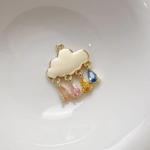 Macro detail of 14K gold plated cloud pendant with four colorful drop-shaped zircon stones
