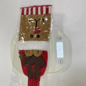 Macro view of a Christmas knitted reindeer stocking on a scale showing 43.1g weight detail