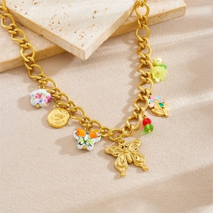 Gold chunky chain necklace featuring colorful ceramic flower and butterfly charms