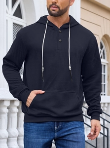 Detail of navy blue hoodie featuring herringbone knit texture and buttoned neckline