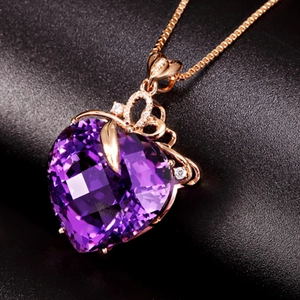 Detailed close-up of heart-shaped amethyst pendant with floral design and 18K rose gold chain