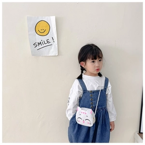 Toddler girl wearing a cute white cartoon cat crossbody bag with 3D pink ears