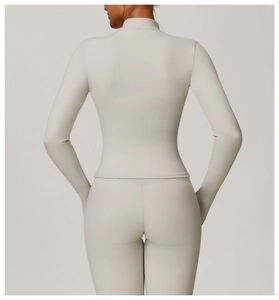 Detail of slim fit back design on light gray long sleeve yoga set with high waist leggings