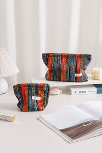 Close-up of colorful striped knitted storage bags with woven H & R BAG label