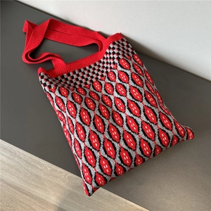 Detail of red geometric knit tote bag showing soft woven texture and diamond pattern weave