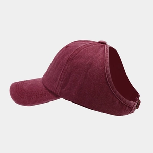 Detail of wine red ponytail baseball cap showing washed cotton fabric and large back opening