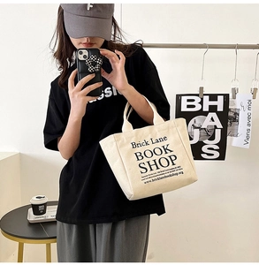 Detailed shot of beige canvas tote bag with Brick Lane Book Shop black printed text