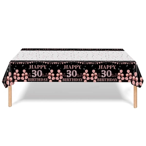 Detail of black and rose gold 30th birthday tablecloth with festive star balloon patterns