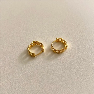 Detail of small gold twisted chain stud earrings made of 925 sterling silver material