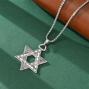 Close-up of Star of David pendant with vintage textured engraving on silver chain