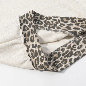 Detailed view of heather grey hoodie fabric with leopard print lining and seam stitching