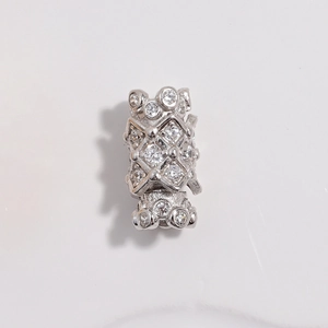 Macro view of S925 silver cylinder clasp with cubic zirconia and hollow diamond pattern