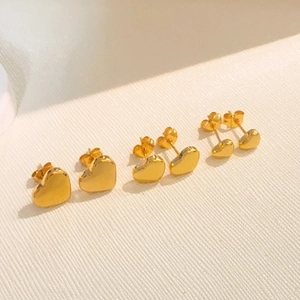 Three pairs of golden titanium steel heart stud earrings in small, medium, and large sizes