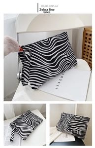 Detailed view of fashion zebra print envelope clutch bag with leather wristlet strap