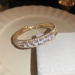 Macro shot of sparkling zircon pavé on a gold layered bracelet with light reflections