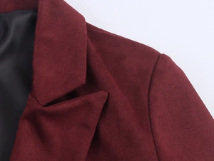 Close-up of deep red faux suede coat lapel with premium texture and black lining details