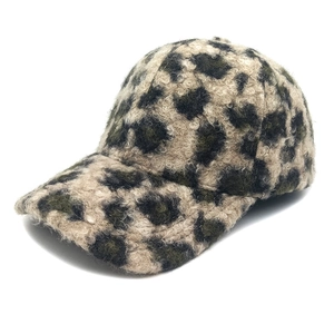 Close-up of leopard print fluffy faux fur baseball cap with plush lamb wool texture