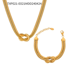 Close-up of golden stainless steel jewelry set with knot design snake bone chains