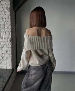 Back view of apricot off-shoulder knit sweater with ribbed texture and long sleeves