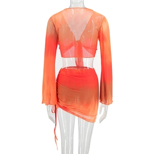 Detail view of tie-dye orange mesh top with back tie lace-up and drawstring skirt