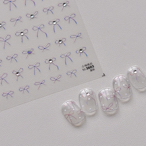 Holografische Schleifen-Nagelsticker mit Strasssteinen für glänzendes Kristall-Nageldesign