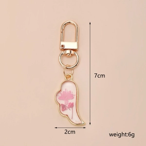 Detail view of pink dried flower wing pendant with dimensions 7cm x 2cm and 6g weight