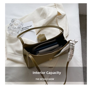 Top view of olive green baguette bag showing spacious interior with floral scarf detail