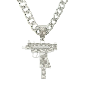 Close-up of a silver-toned handgun pendant necklace with clear sparkling rhinestones