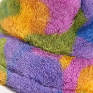 Close-up of soft rainbow faux fur material with plush texture for winter bucket hats