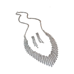 Silver geometric necklace and tassel earring set with sparkling cubic zirconia on white
