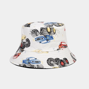 Close-up of white bucket hat with colorful cartoon monster truck prints and black lining