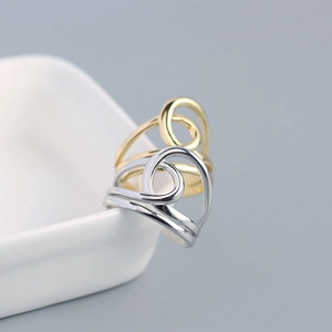 Detailed view of layered S925 sterling silver open rings in gold and silver finishes