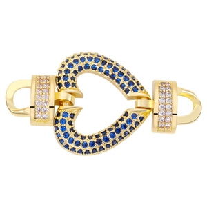 Macro shot of gold heart jewelry clasp with blue and pink cubic zirconia stones