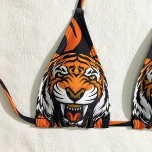 Close-up of tiger print bikini top with vibrant orange and black animal patterns