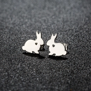 Macro shot of polished stainless steel rabbit stud earrings with hollow heart details