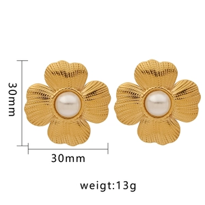 Detail of 30mm golden flower earrings with textured petals and center pearl