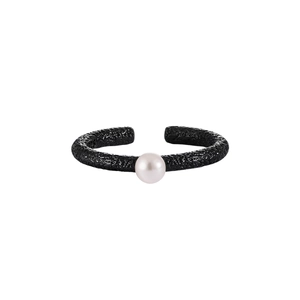 Detail view of a textured open ring with a single white pearl on a clean white background
