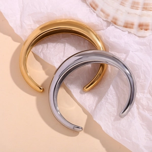Detailed view of 18K gold and silver plated stainless steel open bangles with mirror polish
